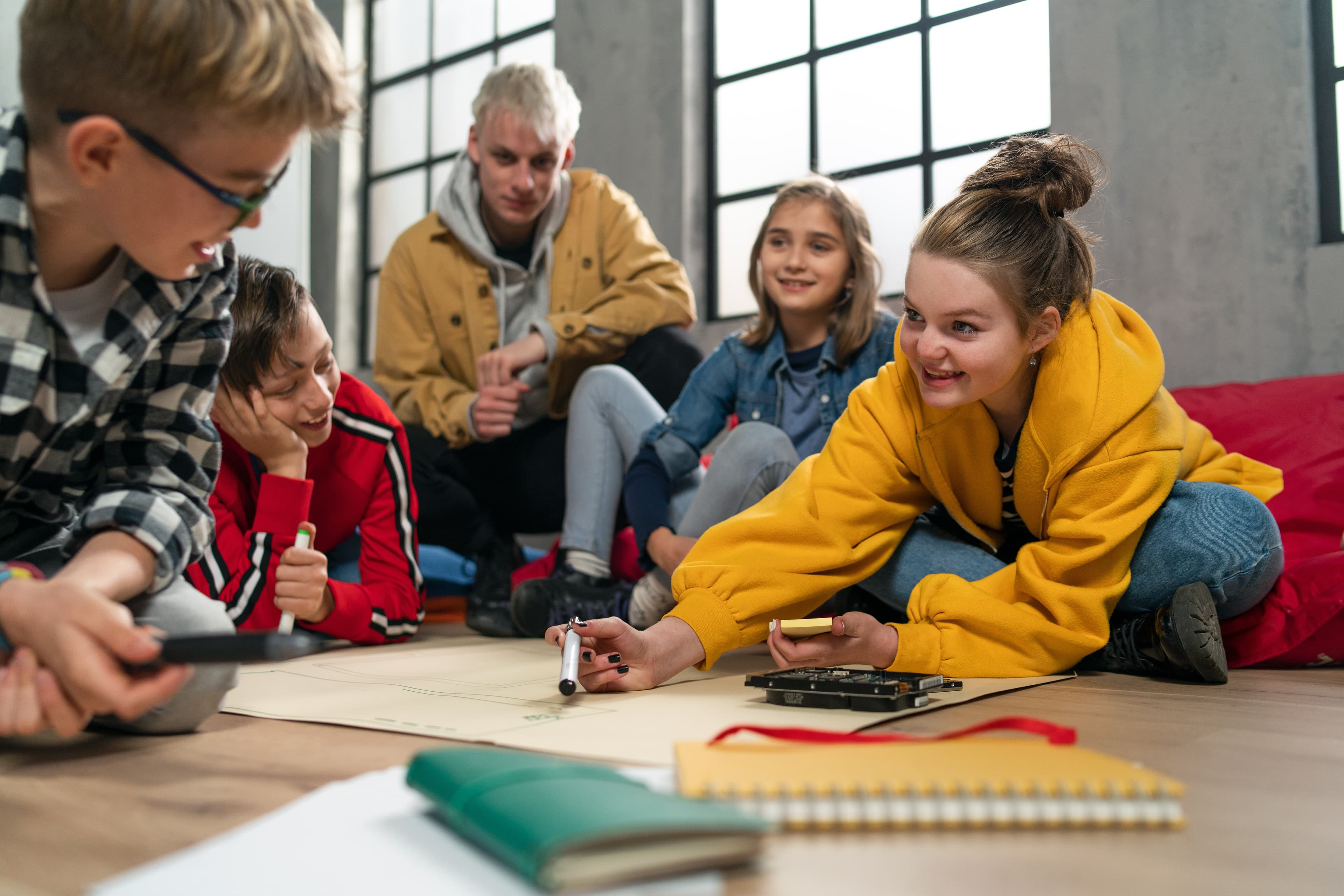 Jugendliche arbeiten gemeinsam an einem Schulprojekt zur Stärkung von Selbstkompetenz